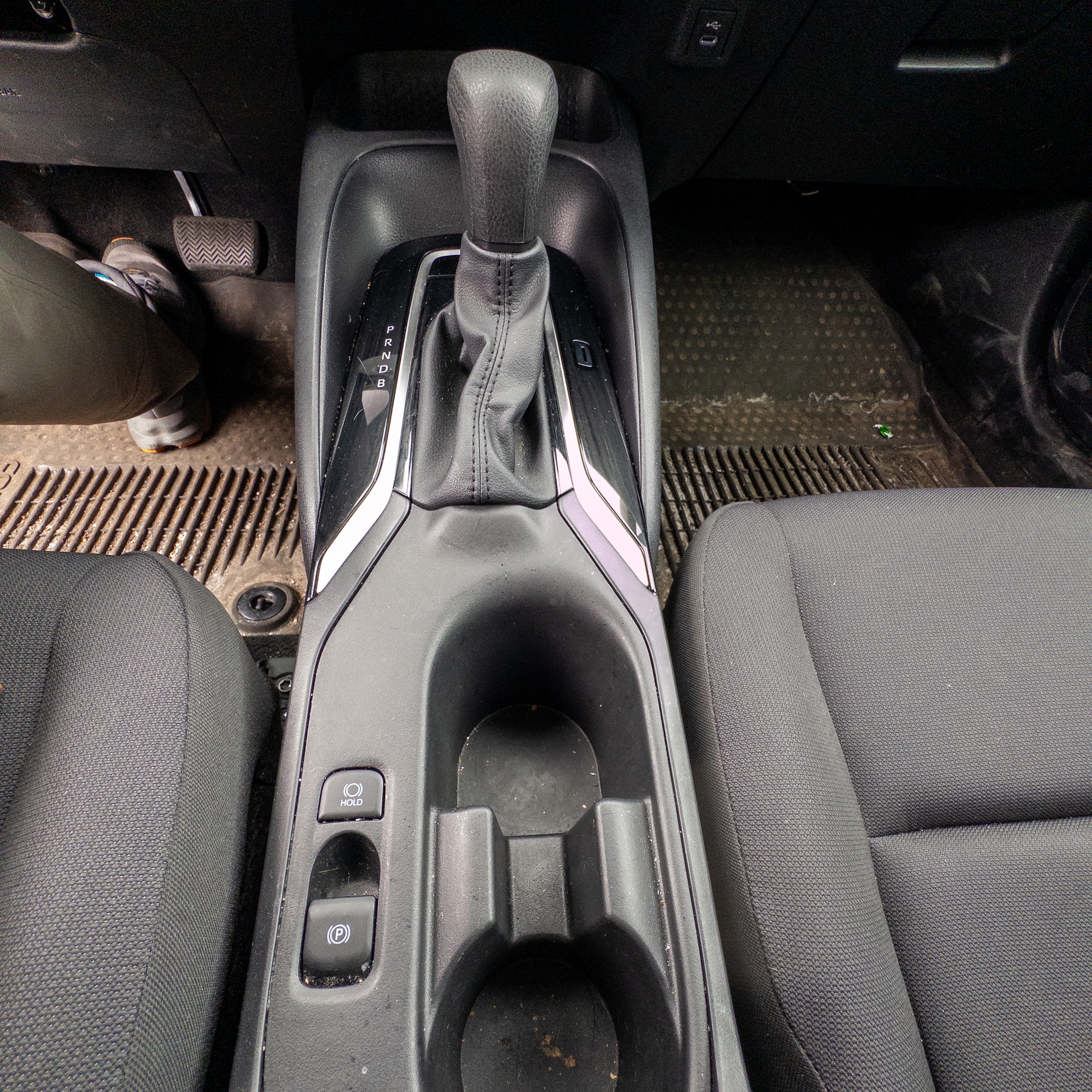 A photo of the Toyota Corolla parking brake switch, located in the center console