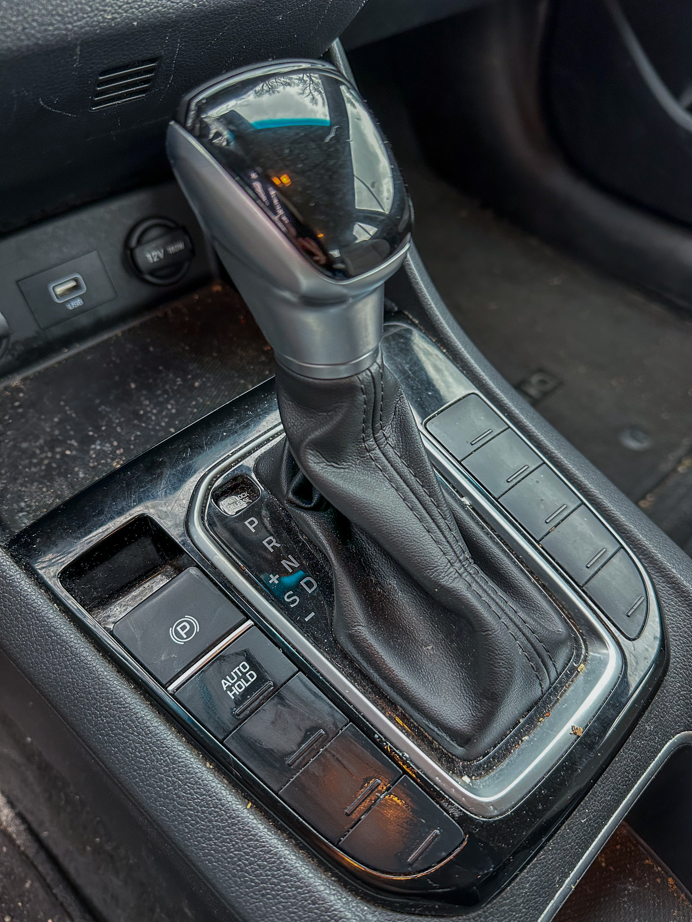 A photo of the center console of the Hyundai Ioniq, showing the parking brake