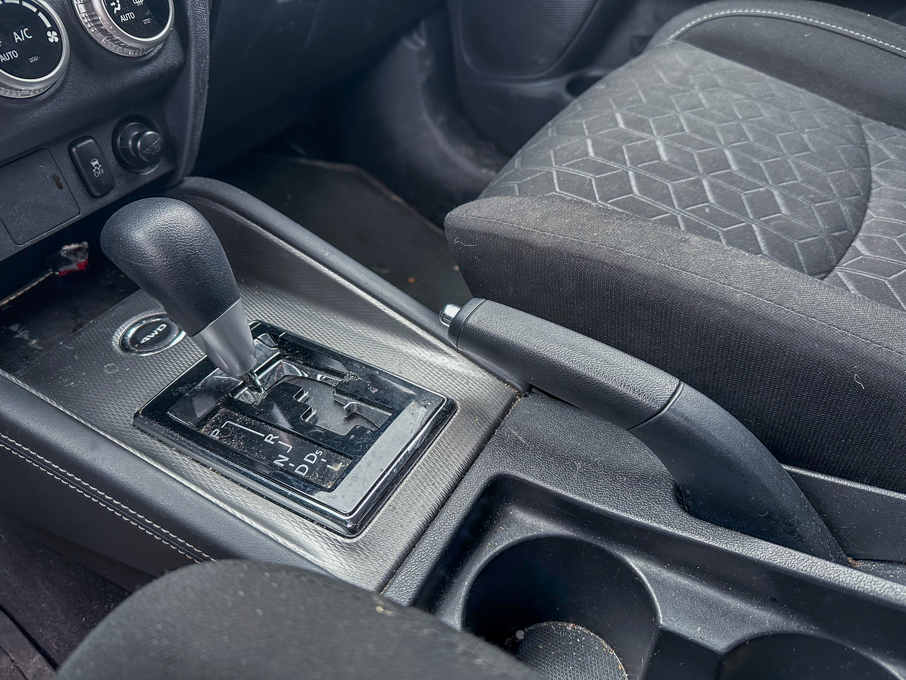 A photo of the Mitsubishi Outlander Sport parking brake lever in its off position, located in the center console